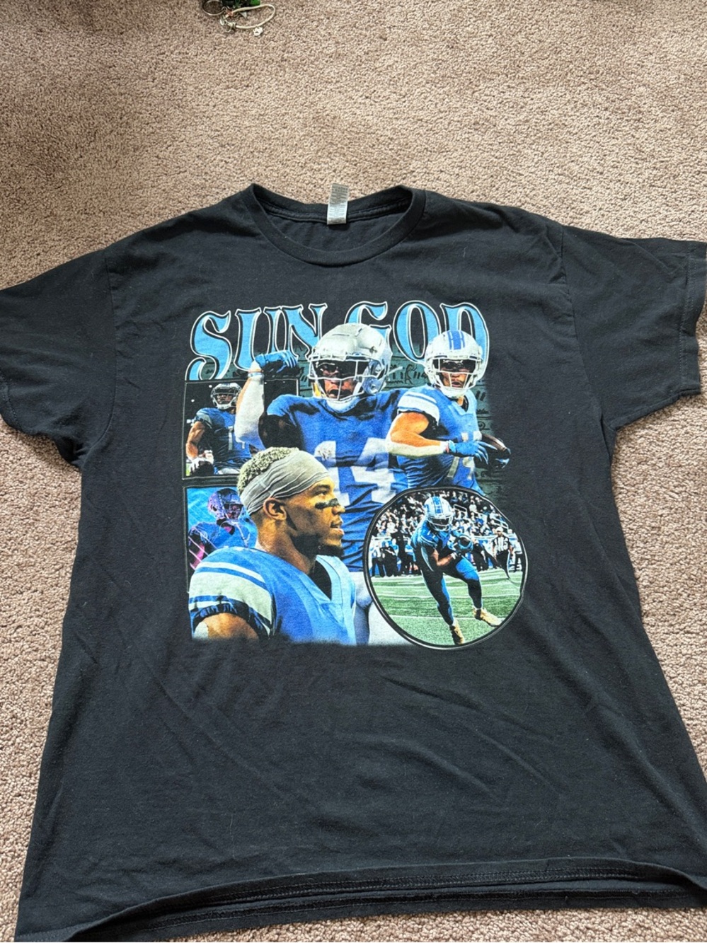 Amon-Ra St. Brown Black Graphic 'Sun God' Football Tee with Blue Accents